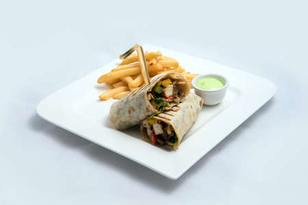 A low contrast Hero shot of a Chicken Pimiento sandwich with samurai & alger sauce & fries on the side, on a minimal white background with a 30 degree angle from diagonal perspectiveの写真素材