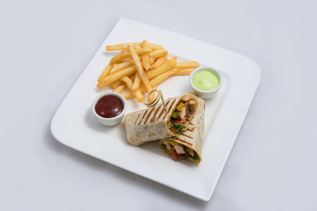 A low contrast Hero shot of a Chicken Pimiento sandwich with samurai & alger sauce & fries on the side, on a minimal white background with a 30 degree angle from diagonal perspectiveの写真素材