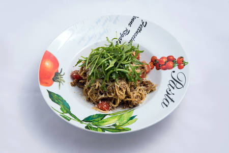 A low contrast lateral Hero shot of a Tuna pasta /  tuna tapenade with olives, tomato & salad, on a minimal white background with a 30 degree angle from zoomed horizontal perspectiveの写真素材