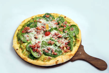 "A high contrast Hero shot of a Bruschetta Al Pesto Spinaci Pizza, on a minimal white background with a 60 degree angle from zoomed out frontal perspective. Incredients include Bruschetta bread, Pesto sauce & spinach. Bruschetta -is Toasted italian bread drenched in oil.
Pesto is Italian green sauce made from basil leaves, parmesan cheese, pine nuts, and olive oil."の写真素材