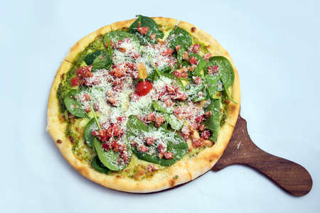 "A high contrast Hero shot of a Bruschetta Al Pesto Spinaci Pizza, on a minimal white background with a 90 degree angle from zoomed out vertical perspective. Incredients include Bruschetta bread, Pesto sauce & spinach. Bruschetta -is Toasted italian bread drenched in oil.
Pesto is Italian green sauce made from basil leaves, parmesan cheese, pine nuts, and olive oil."の写真素材