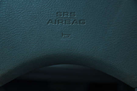 Leather texture on the steering wheel of a car showing the srs air bag and hornのeditorial素材