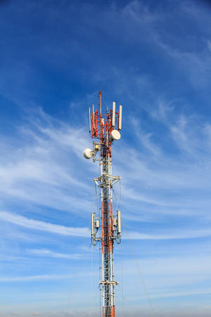 Telecommunication tower on blue skyの写真素材