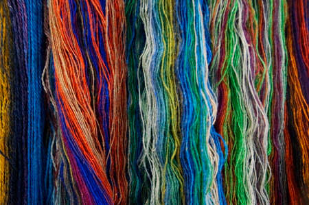 Background with multicolored threads of woolen yarnの写真素材