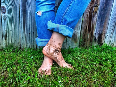 Yard work with muddy feetの素材