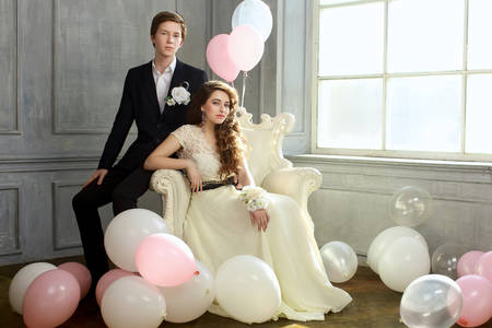 Cute Teenage Prom Couple in beautiful interiorの写真素材