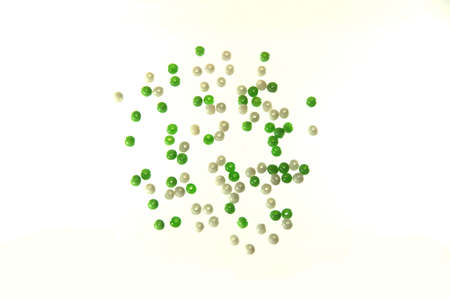 Some green and white imitation jewelry pebbles over whiteの写真素材