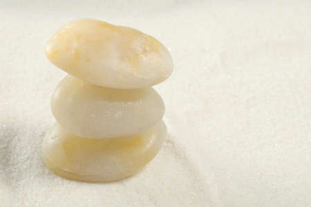 Symbol of Zen with three rocks on the sandの写真素材