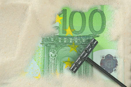 Finding hundred euros in the sandの写真素材