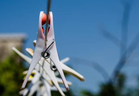clothespins on a rope on the background of sky