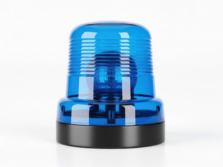 A close-up shot of a blue rotating beacon light, often used for emergency vehicles or industrial signaling, isolated on a seamless white surface.の写真素材