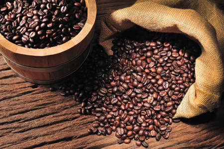 Coffee beans in burlap sack and wooden bucketの写真素材