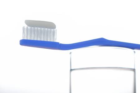 toothbrush on water glass. Isolated on a white.