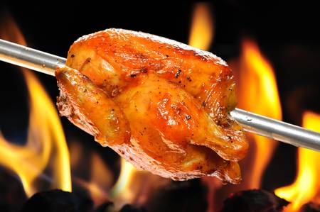 roasted chicken on flame backgroundの写真素材