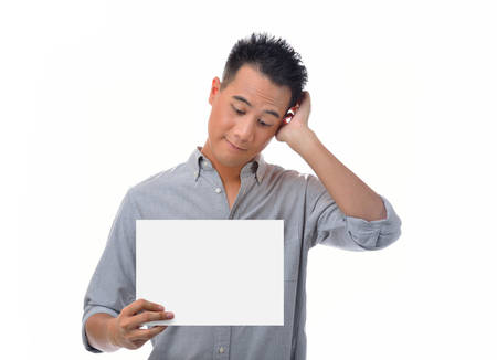 Young man holding blank billboardの写真素材