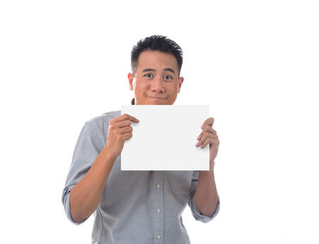 Young man holding blank billboardの写真素材