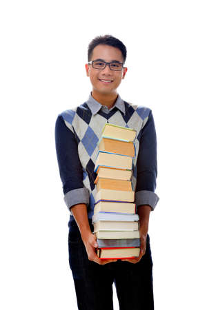 Young student holding books isolated over white background の写真素材