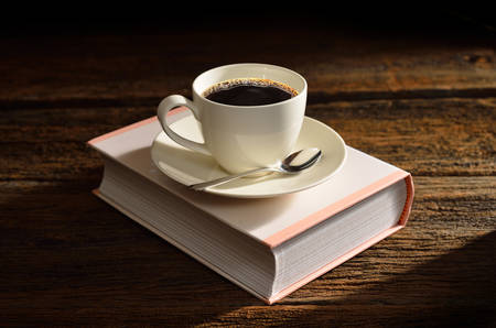 Cup of coffee without smoke on a book-like box 