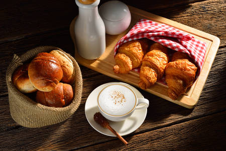 A cup of cappuccino and bread
