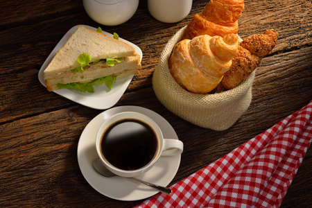 Coffee cup with sandwich and croissant の写真素材