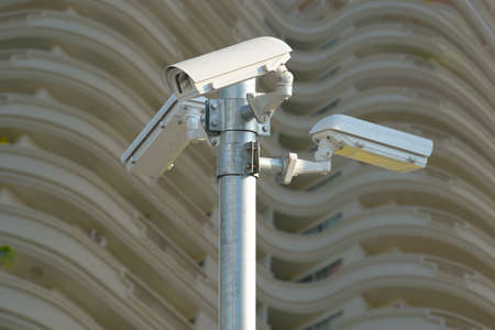 Three security cameras on front of building,  CCTV の写真素材