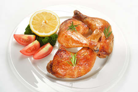 Grilled chicken thigh with vegetables on white plate の写真素材