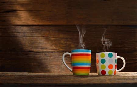 Cup of coffee with smoke on old wooden backgroundの写真素材
