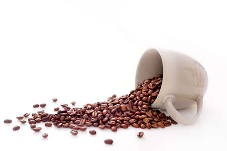 Coffee beans in coffee cup isolated on whiteの写真素材