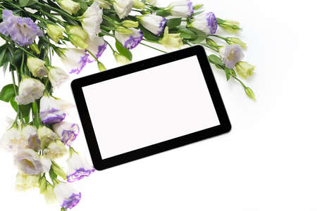 Tablet computer and beautiful bouquet of flowers isolated on whiteの写真素材