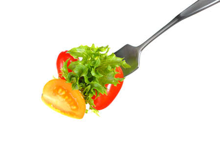 Mixed salad on fork isolated on whiteの写真素材