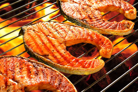 Grilled salmon on the flaming grillの写真素材