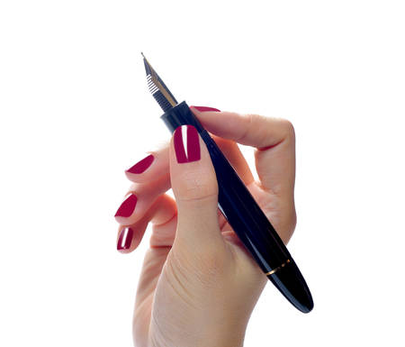 Woman  hand holding a pen isolated on white backgroundの写真素材