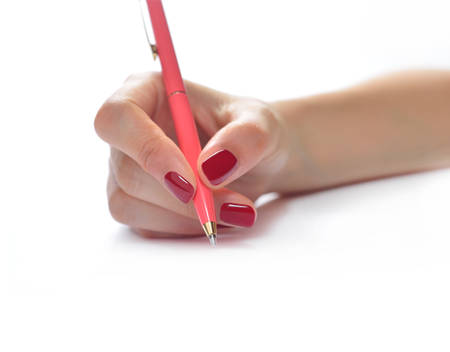 Woman  hand holding a pen isolated on white backgroundの写真素材