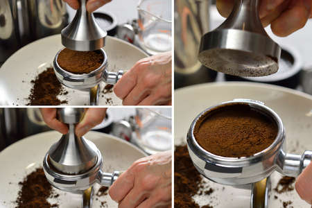 Barista using a tamper to press ground coffee into a portafilterの写真素材