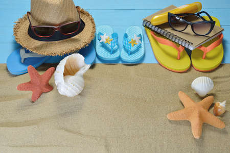 Beach accessories with starfish and seashells on sandy beachの写真素材
