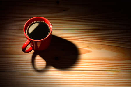 Top view of a cup of coffee on wooden backgroundの写真素材
