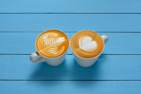 Latte Art, cups of cafe latte on wooden backgroundの写真素材