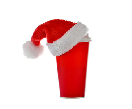 Paper coffee cup with santa's hat on top isolated on white backgroundの写真素材