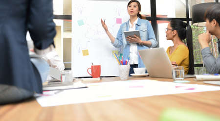 Group of businesspersons having different age in creative business discussing work in the officeの写真素材