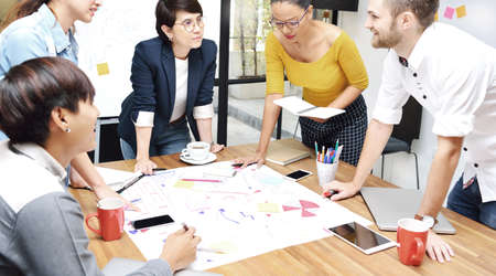 Group of businesspersons having different age in creative business discussing work in the officeの写真素材