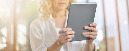 Businesswoman working and using tablet computer in office