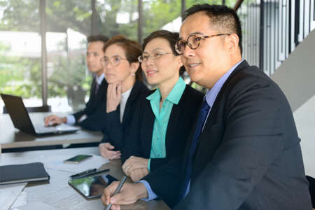 Group of business people discussing and working together during a meeting in office