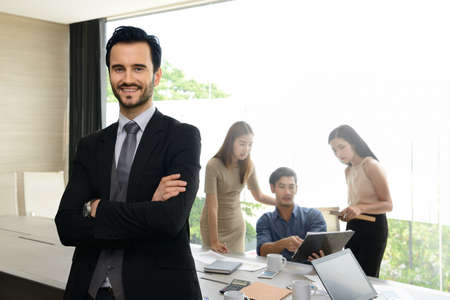 Businessman posing confident and positive in professional workplace officeの写真素材
