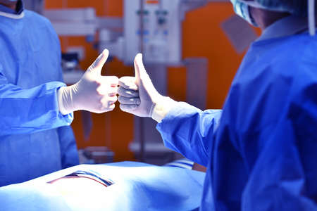 Team surgeon congratulating a successful operation in an operating room
