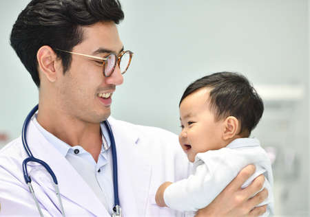 Asian pediatrician is taking care of baby in hospitalの写真素材