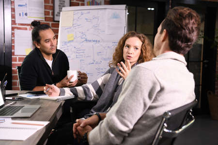 Group of businesspersons in creative business discussing work in the officeの写真素材