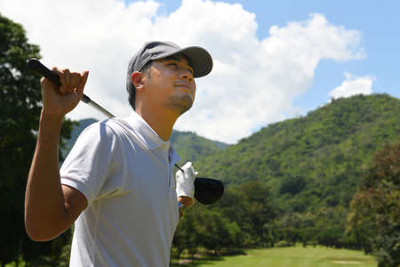 Portrait of handsome young Asian man golfer with golf club