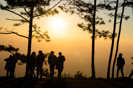 Image of black silhouette of people watching the sunrise on colorful horizon ( Phu kradueng thailand )の写真素材