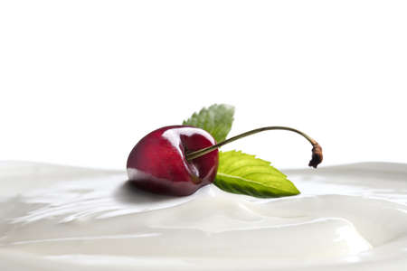 Plain yogurt with fresh cherry on top isolated on white backgroundの写真素材