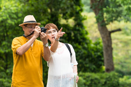 Image of happy romantic Asian senior couple outdoor in parkの写真素材